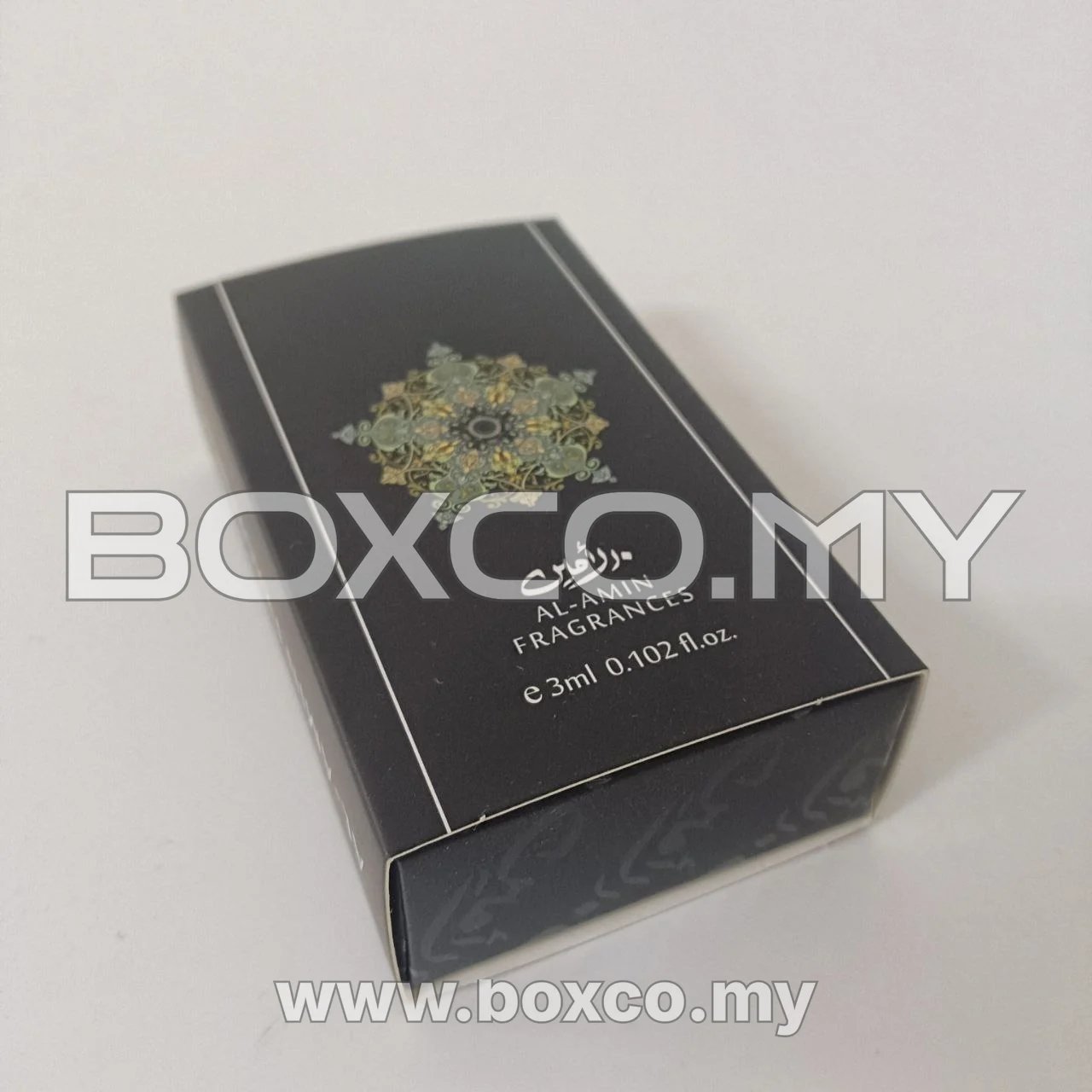 Closed black 3 ml fragrance drawer box with ornate green and gold-toned artwork