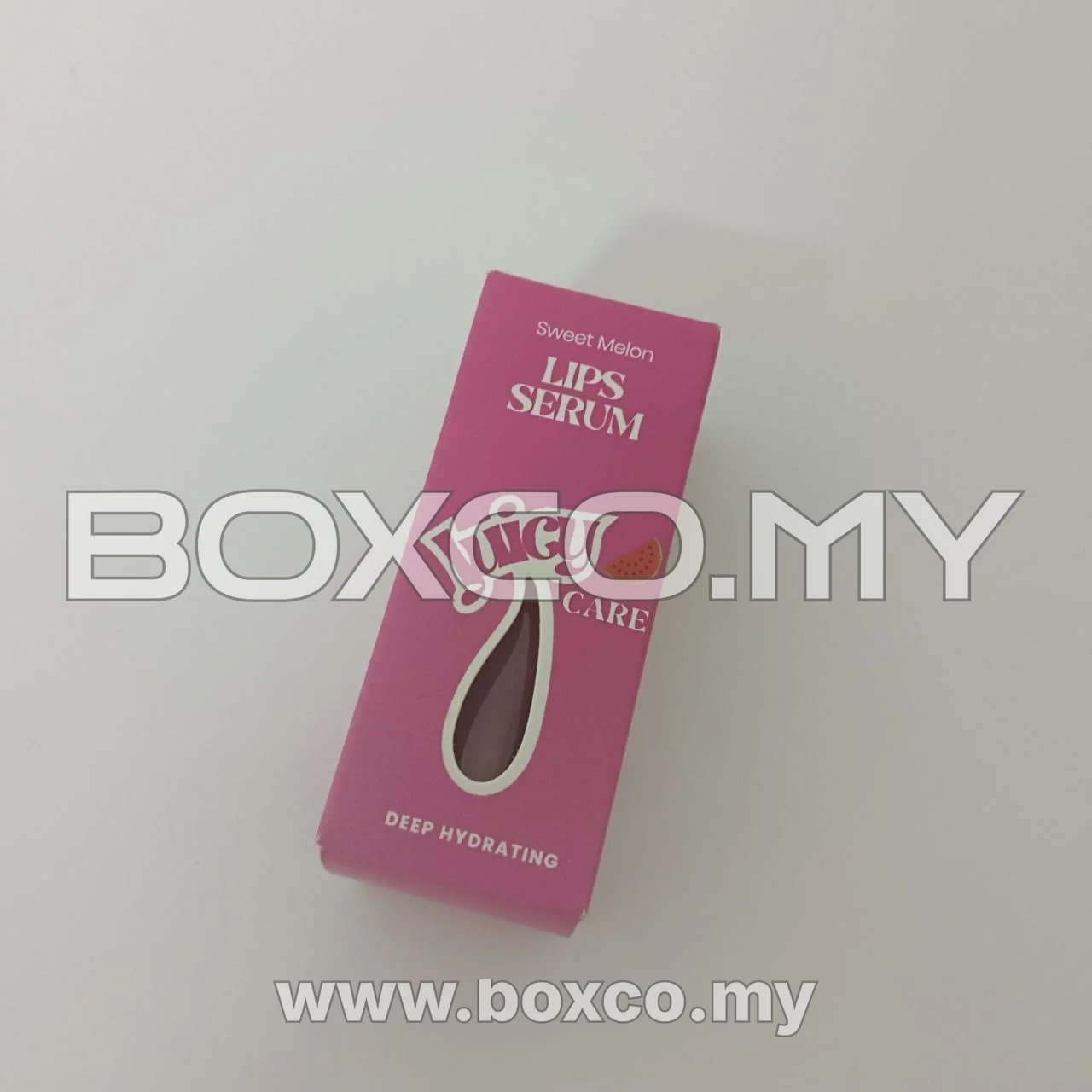 Front view of a pink sweet melon lip serum carton with a central die-cut window